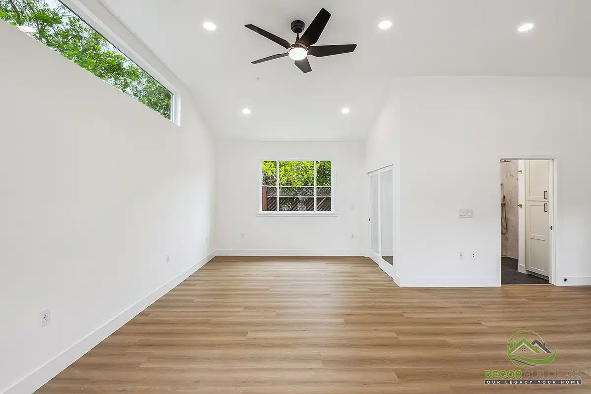 Home renovation featuring a bright open-concept living room with white walls, ceiling fan, hardwood flooring, and large windows in Morgan Hill, CA