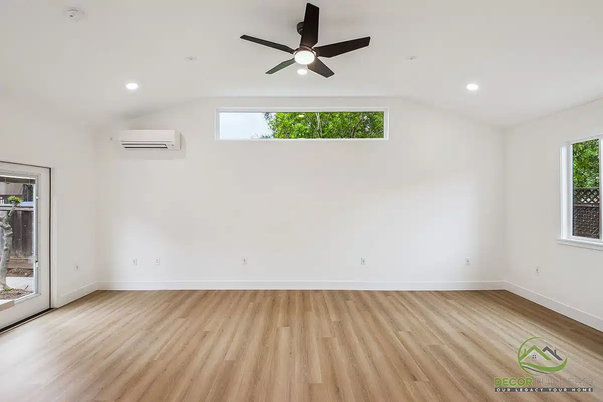 Custom home remodel showcasing an open-concept living area with white walls, hardwood flooring, ceiling fan, and mini split AC unit in Morgan Hill, CA
