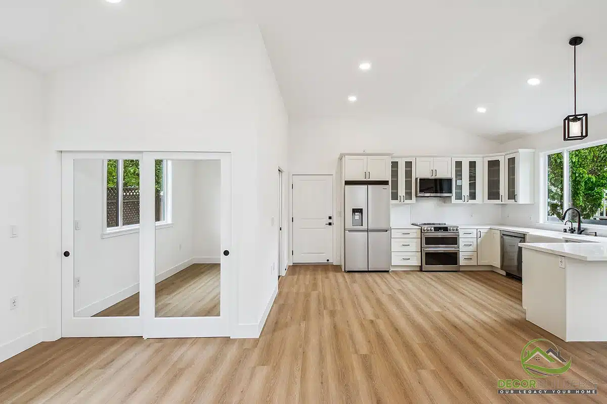 Custom home remodel showcasing an open-concept layout with white cabinetry, hardwood flooring, and recessed lighting in Morgan Hill, CA