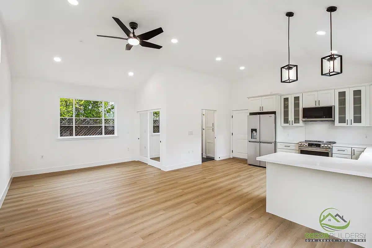 Kitchen renovation showcasing white cabinetry, center island, ceiling fan, pendant lighting, and hardwood flooring in Morgan Hill, CA