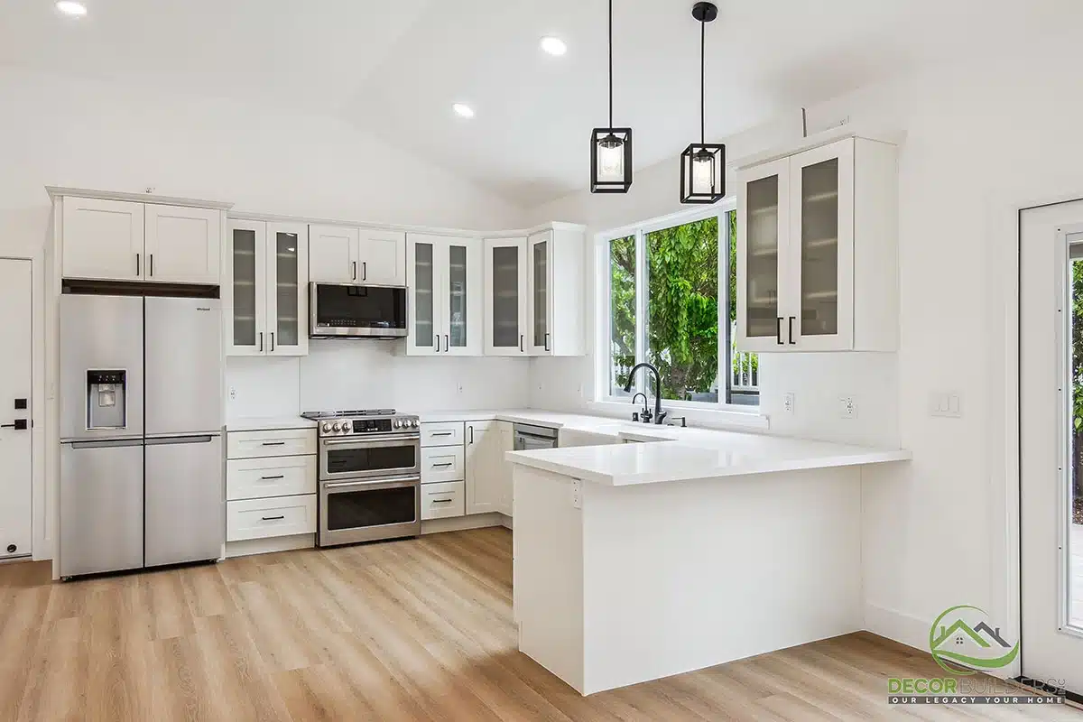 Custom home remodel featuring an open-concept kitchen with white cabinetry, center island, pendant lighting, and hardwood flooring in Morgan Hill, CA
