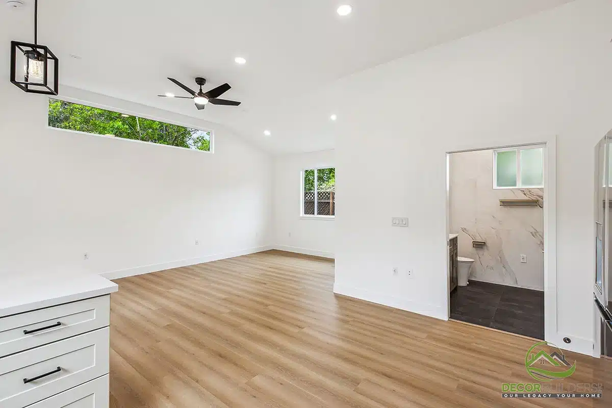 Custom home remodel showcasing an open-concept living area with white walls, hardwood flooring, ceiling fan, and recessed lighting in Morgan Hill, CA