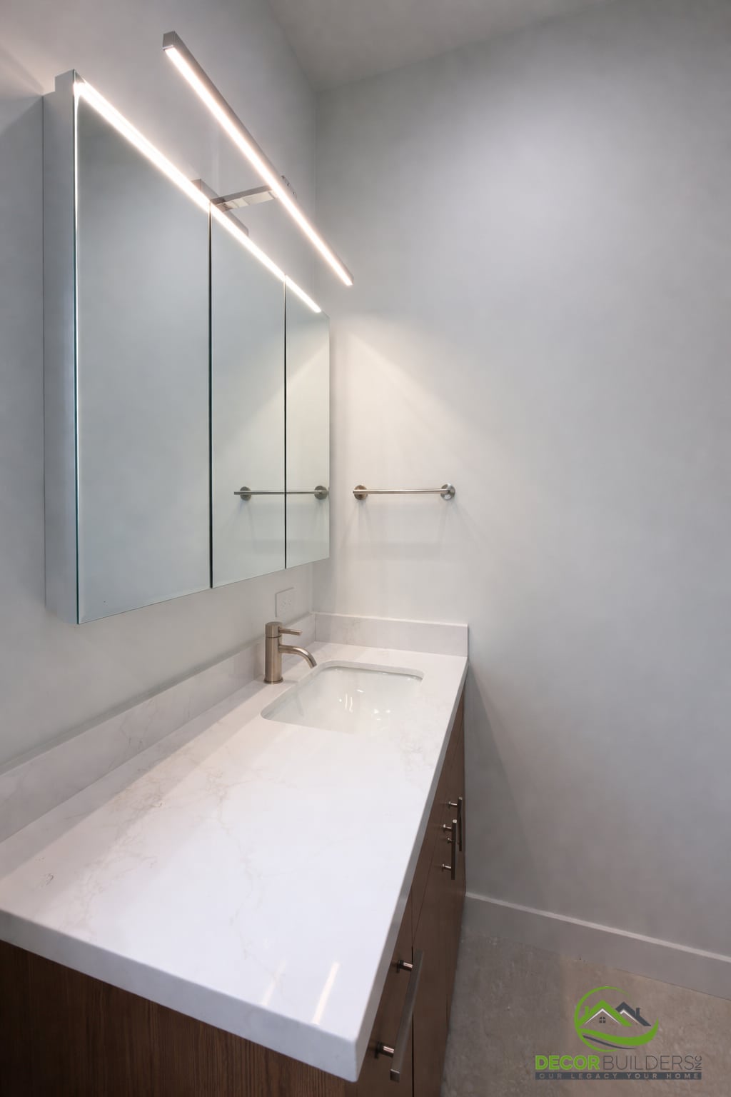 Bathroom remodel with wood vanity, white quartz countertop, and LED mirror cabinet in Sunnyvale CA