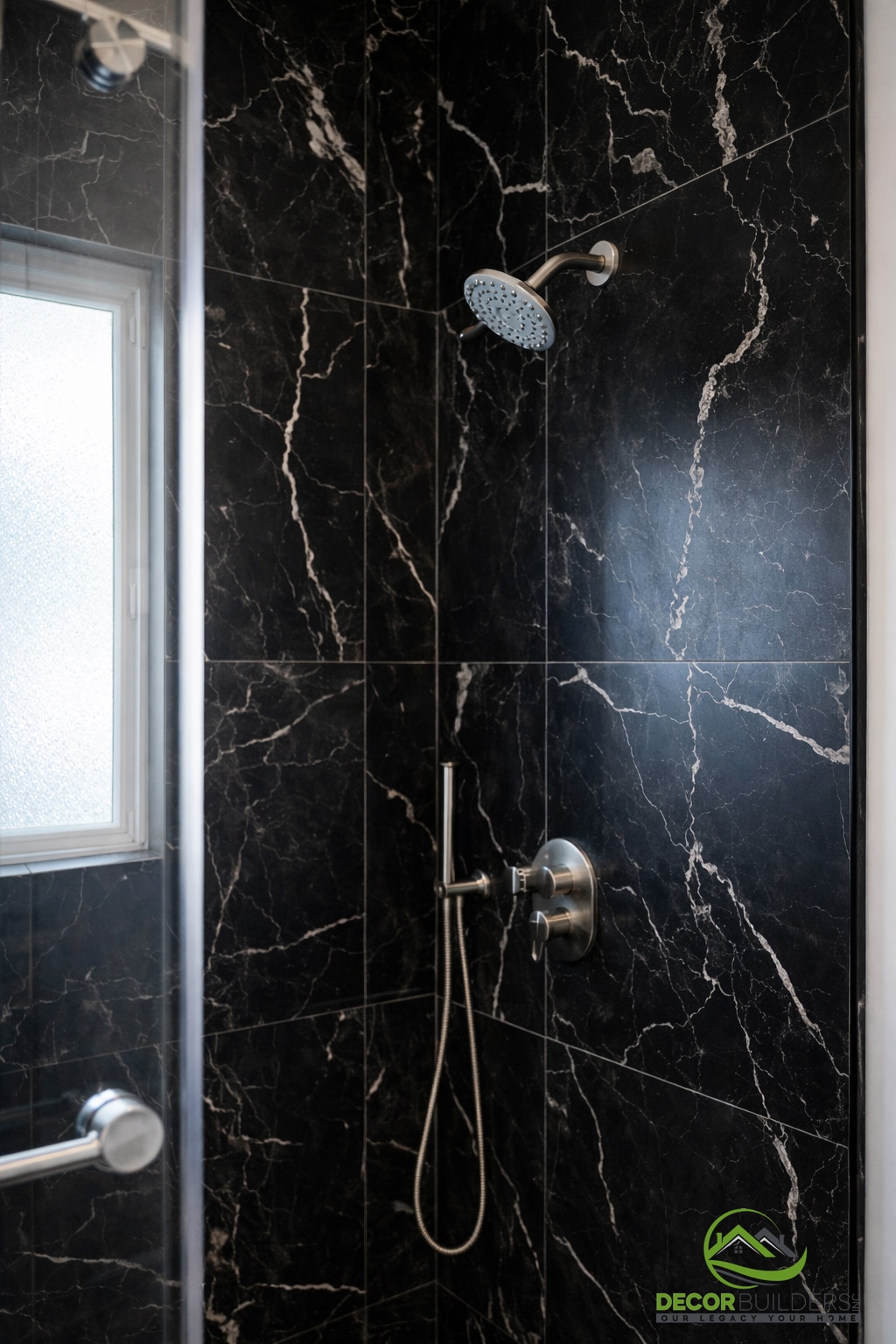 Luxury bathroom renovation featuring a black marble tile walk-in shower with rainfall showerhead and mosaic tile flooring in Palo Alto