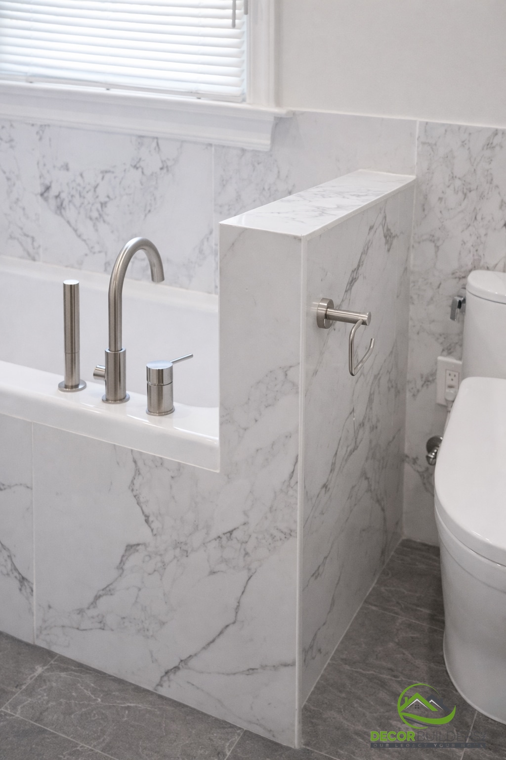 Custom bathroom remodel with a freestanding tub, brushed nickel fixtures, and full marble tile wall surround in Palo Alto