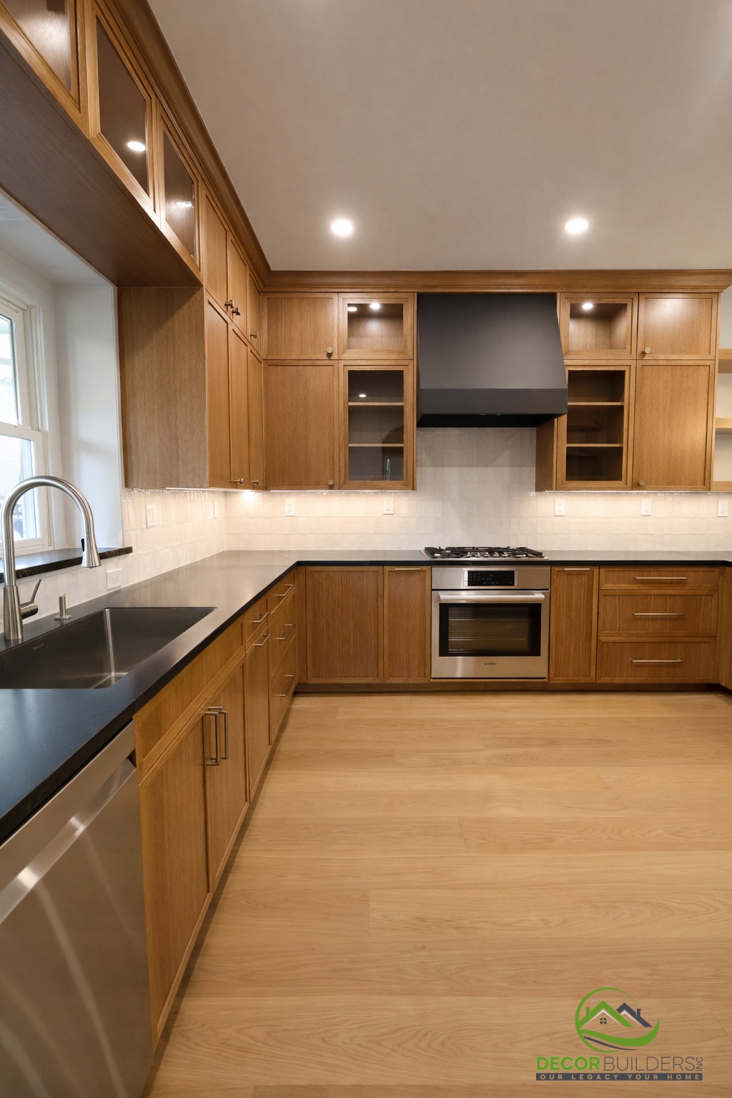 Home addition featuring an open-concept kitchen with warm wood cabinetry, dark countertops, and hardwood flooring in Palo Alto