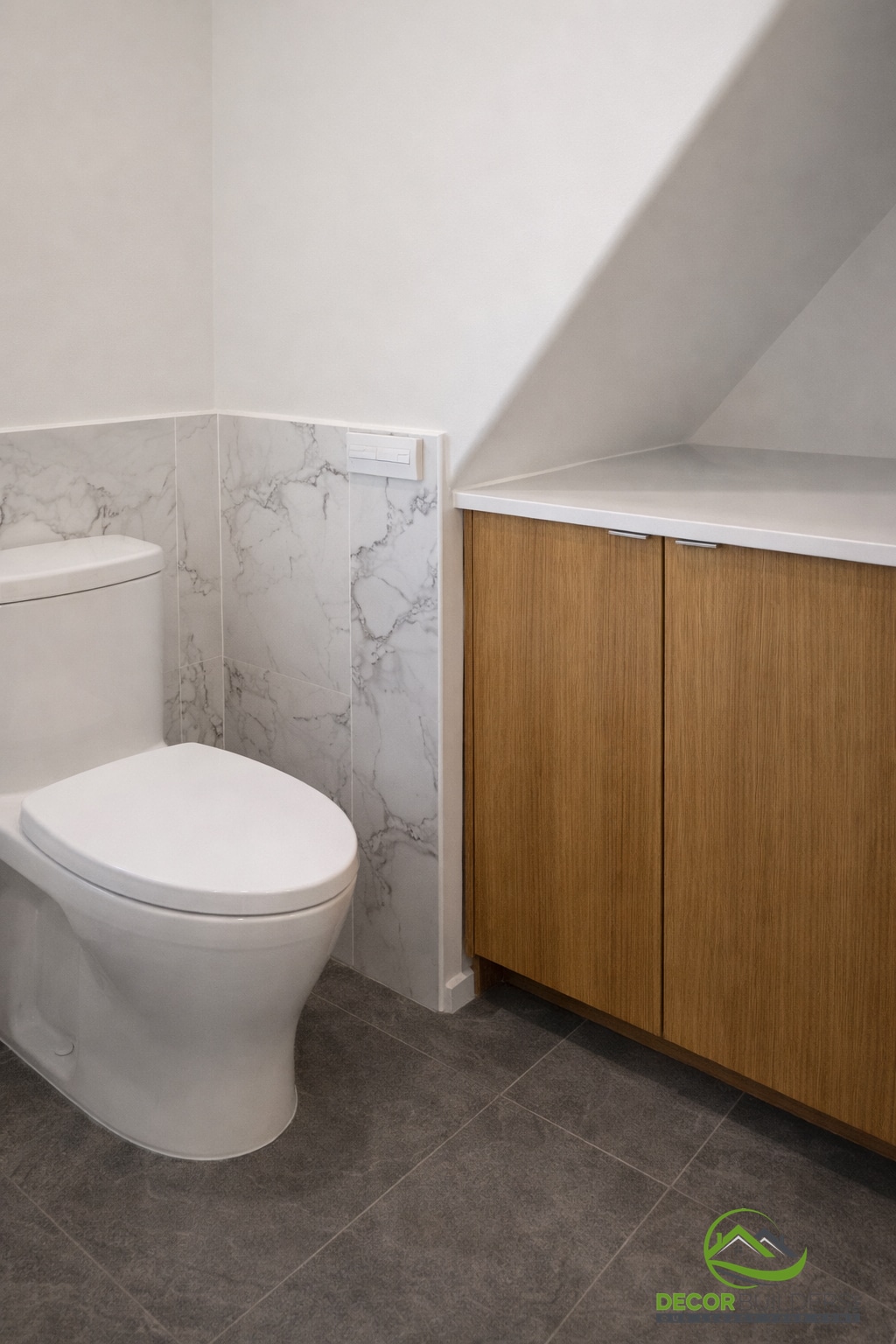 Bathroom remodel with a wall-hung toilet, wood vanity cabinet, and white marble tile walls in Palo Alto