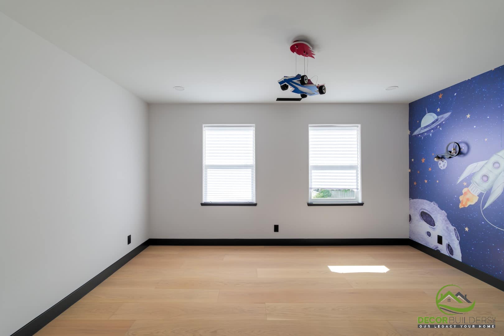 Kids' bedroom with a space-themed mural and hardwood floors, a custom home design detail in Campbell, CA