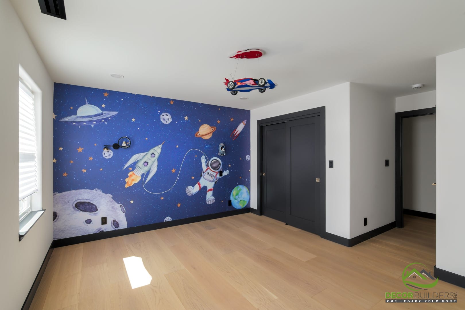 Children's bedroom featuring an astronaut and space mural, designed during a custom home build in Campbell, CA