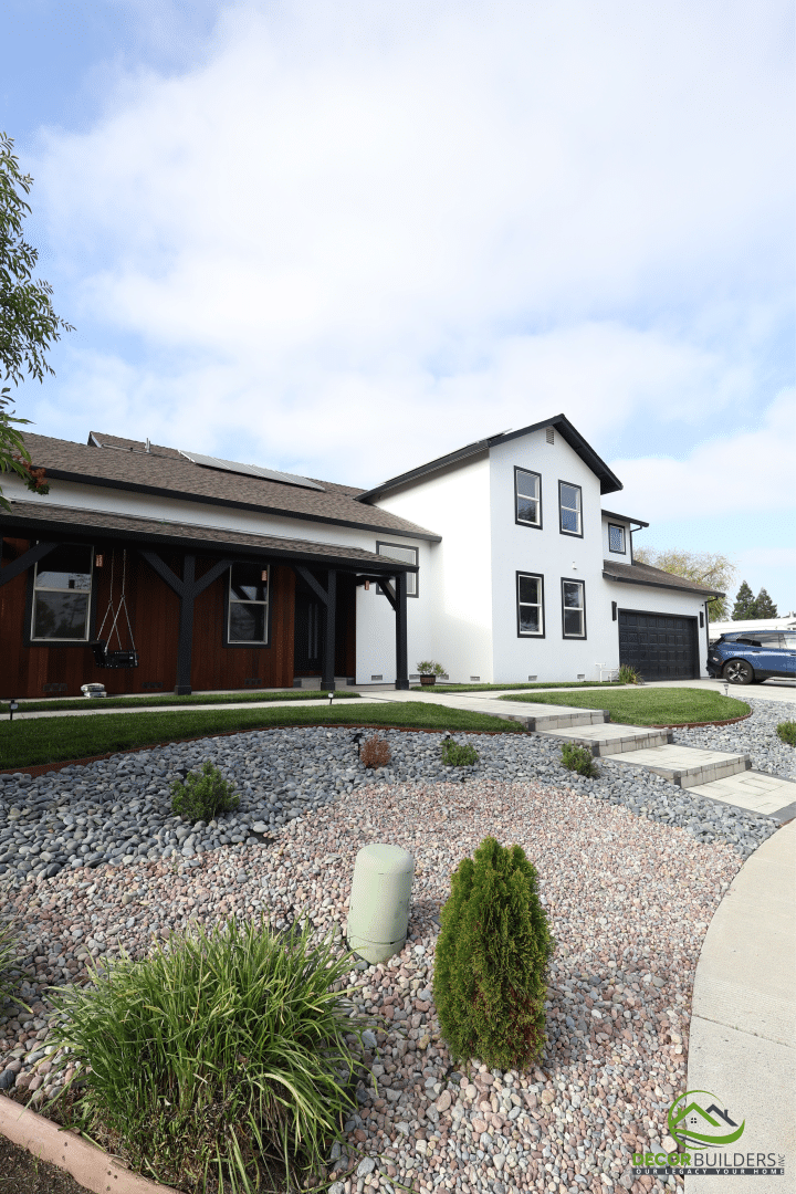 Front exterior of a custom-built home with landscaped yard, gravel beds, and stepping-stone walkway, showcasing landscape design and hardscape installation in Campbell, CA