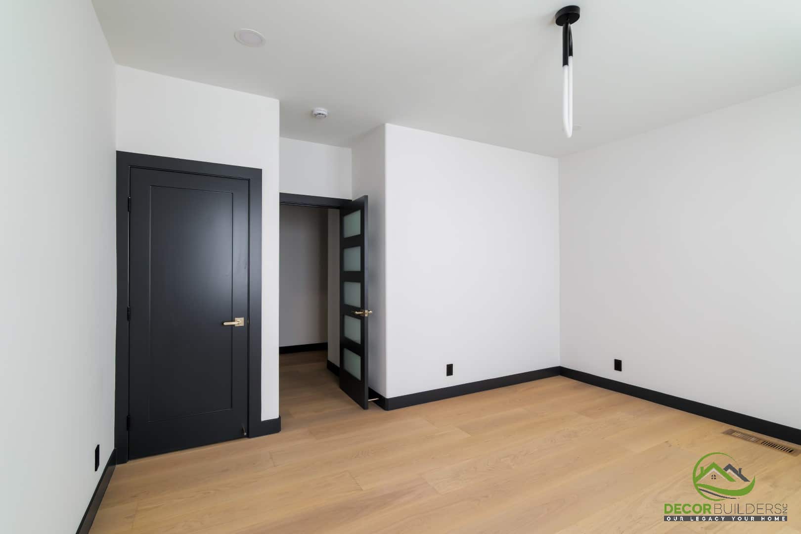 Bedroom with built-in shelving and modern pendant lighting, designed as part of a custom home build in Campbell, CA