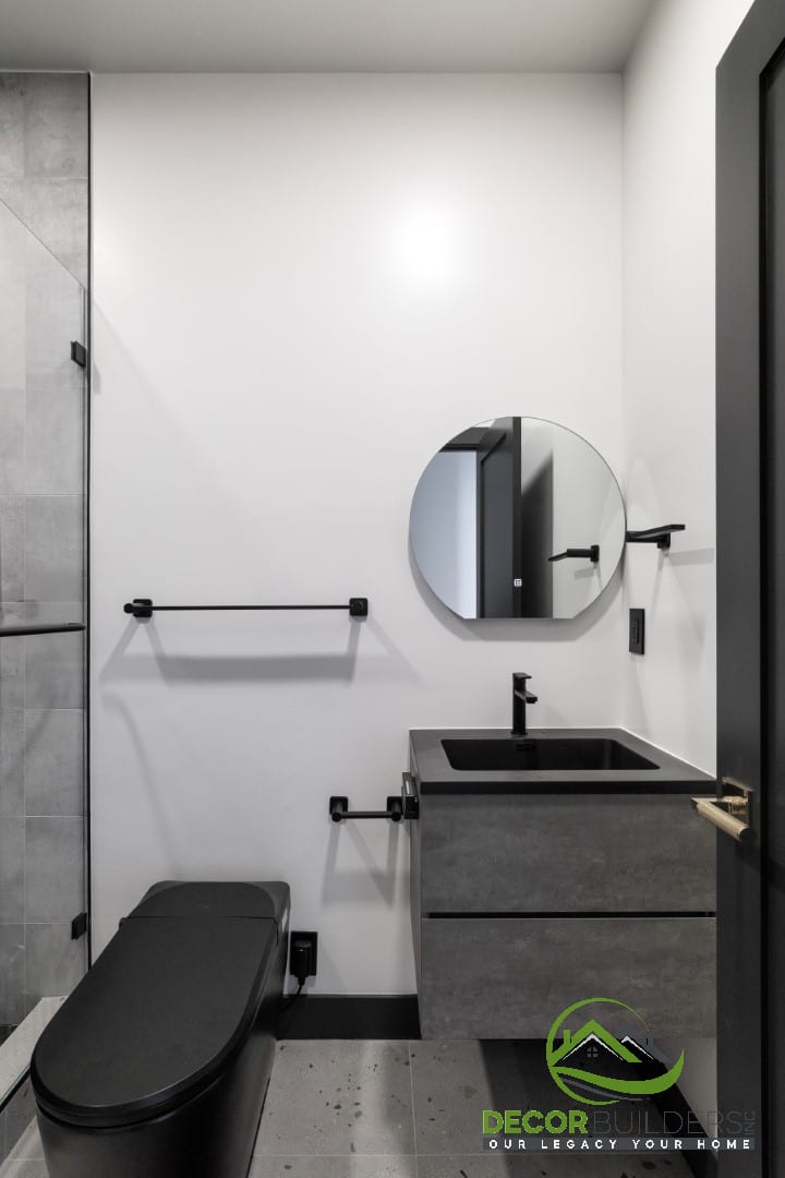 Modern bathroom with concrete-look tile, black fixtures, and round mirror, a bathroom remodeling feature in Campbell, CA