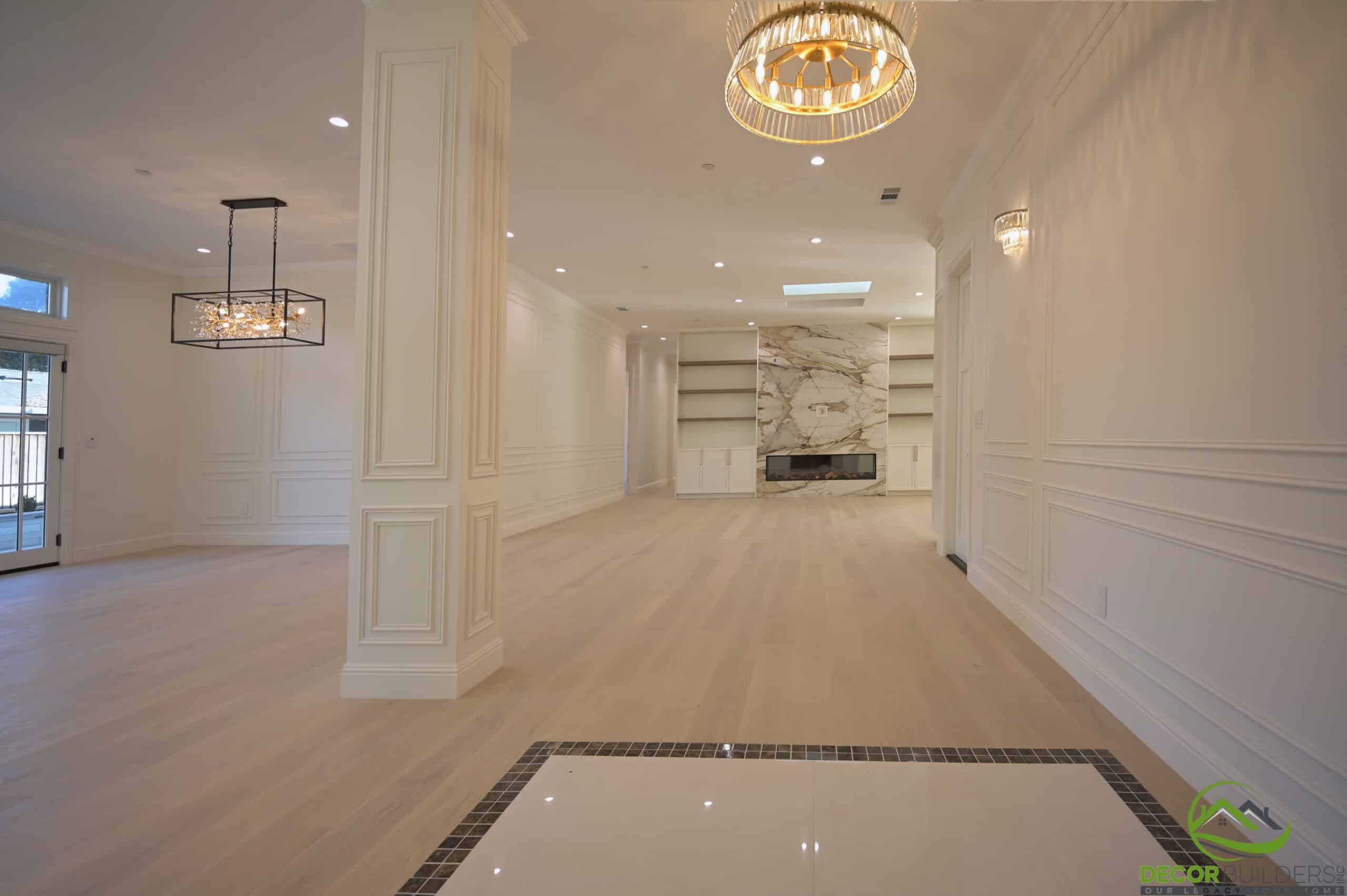 Renovated living and dining area with decorative columns and fireplace, part of a whole home renovation in Cupertino, CA