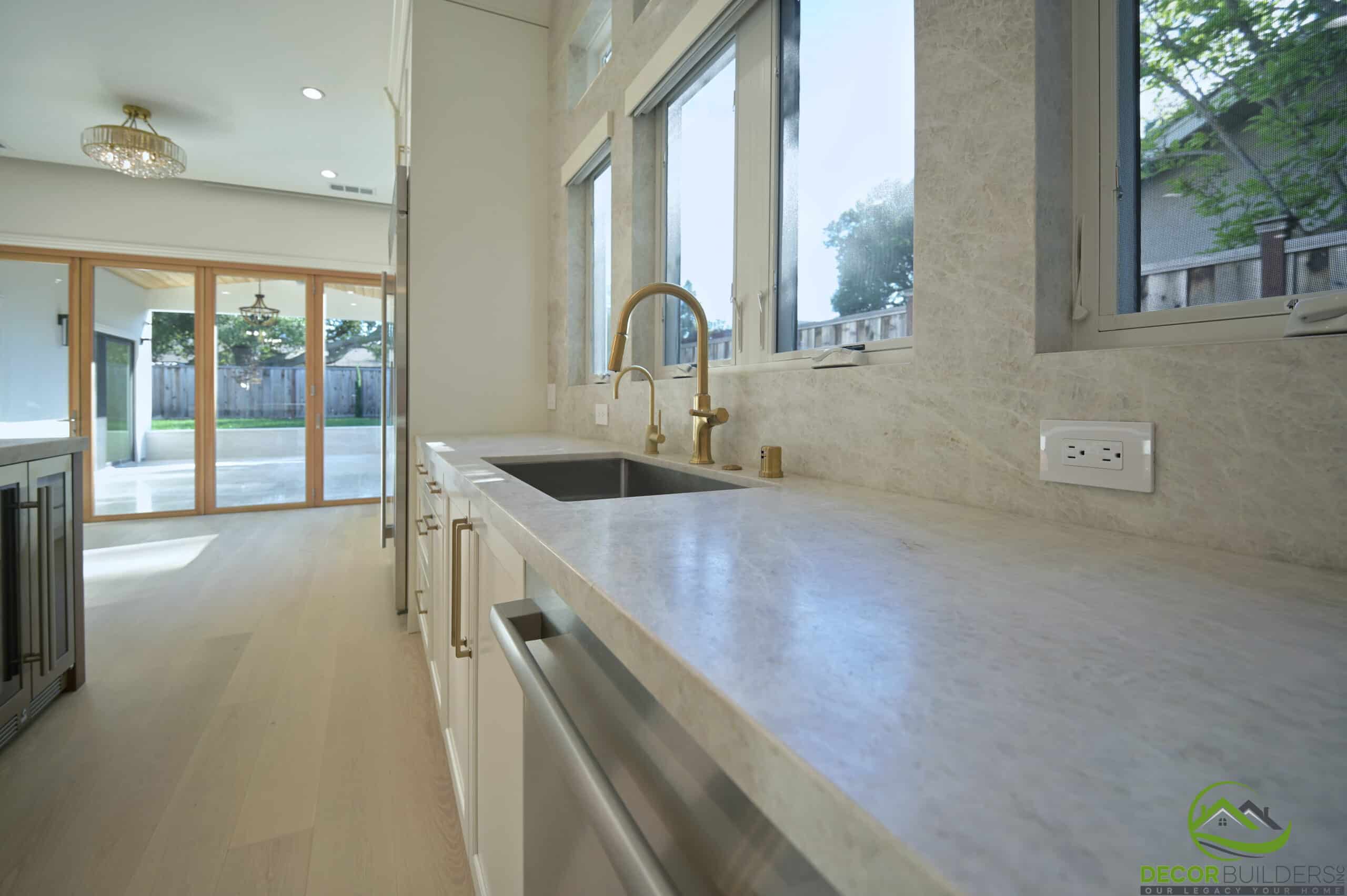 Kitchen counter and sink with sliding glass doors, part of a kitchen renovation in Cupertino, CA