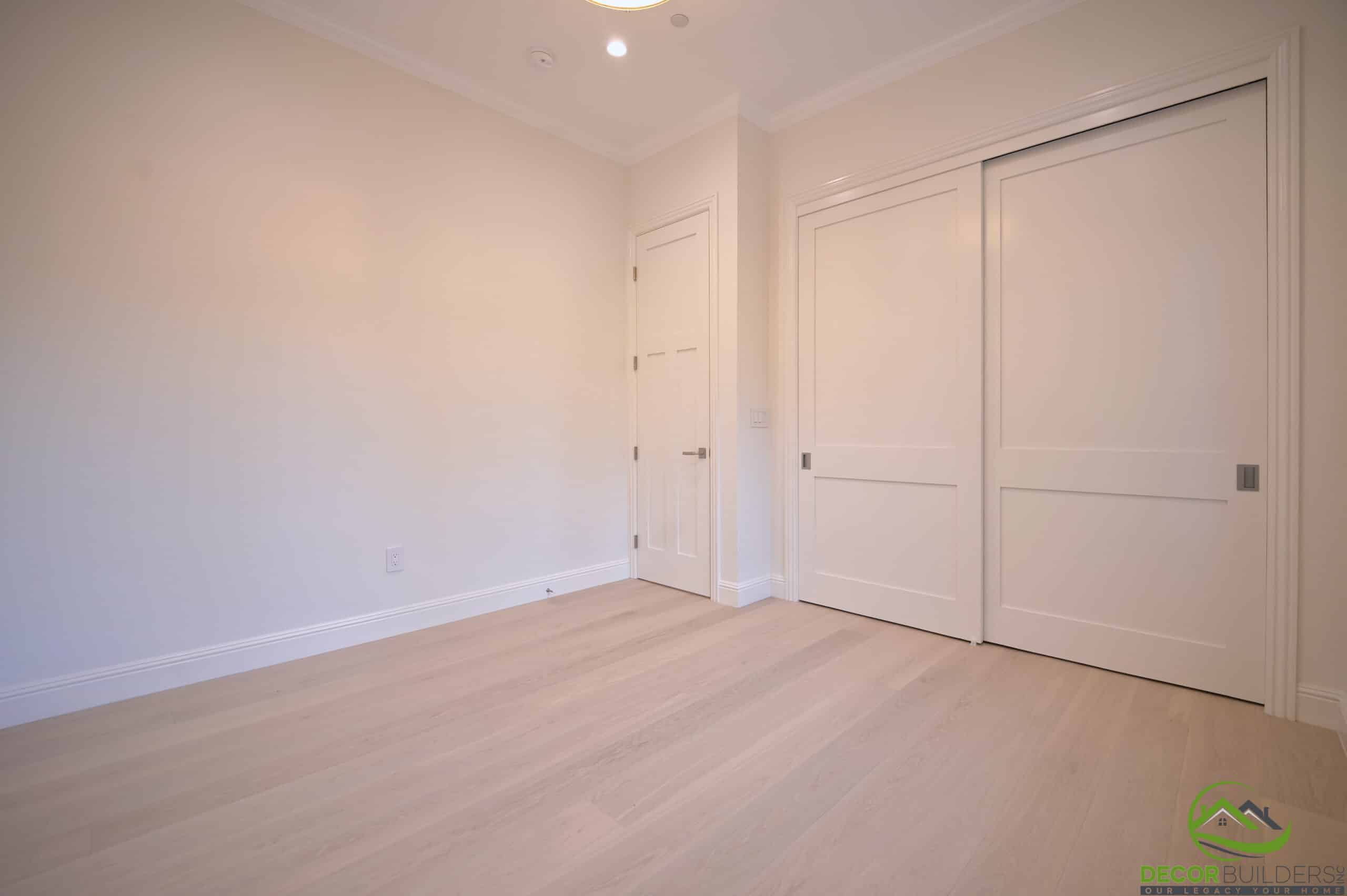Renovated bedroom with hardwood flooring and sliding closet doors in Cupertino, CA