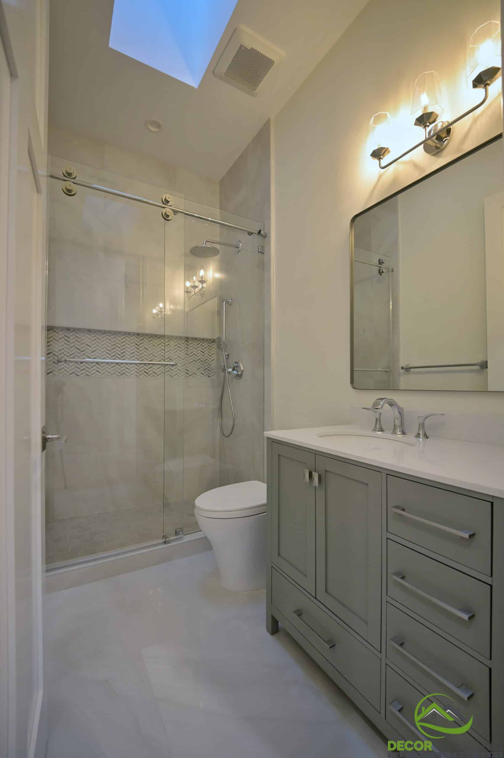 Bathroom featuring a glass shower enclosure and double vanity from a bathroom remodel in Cupertino, CA