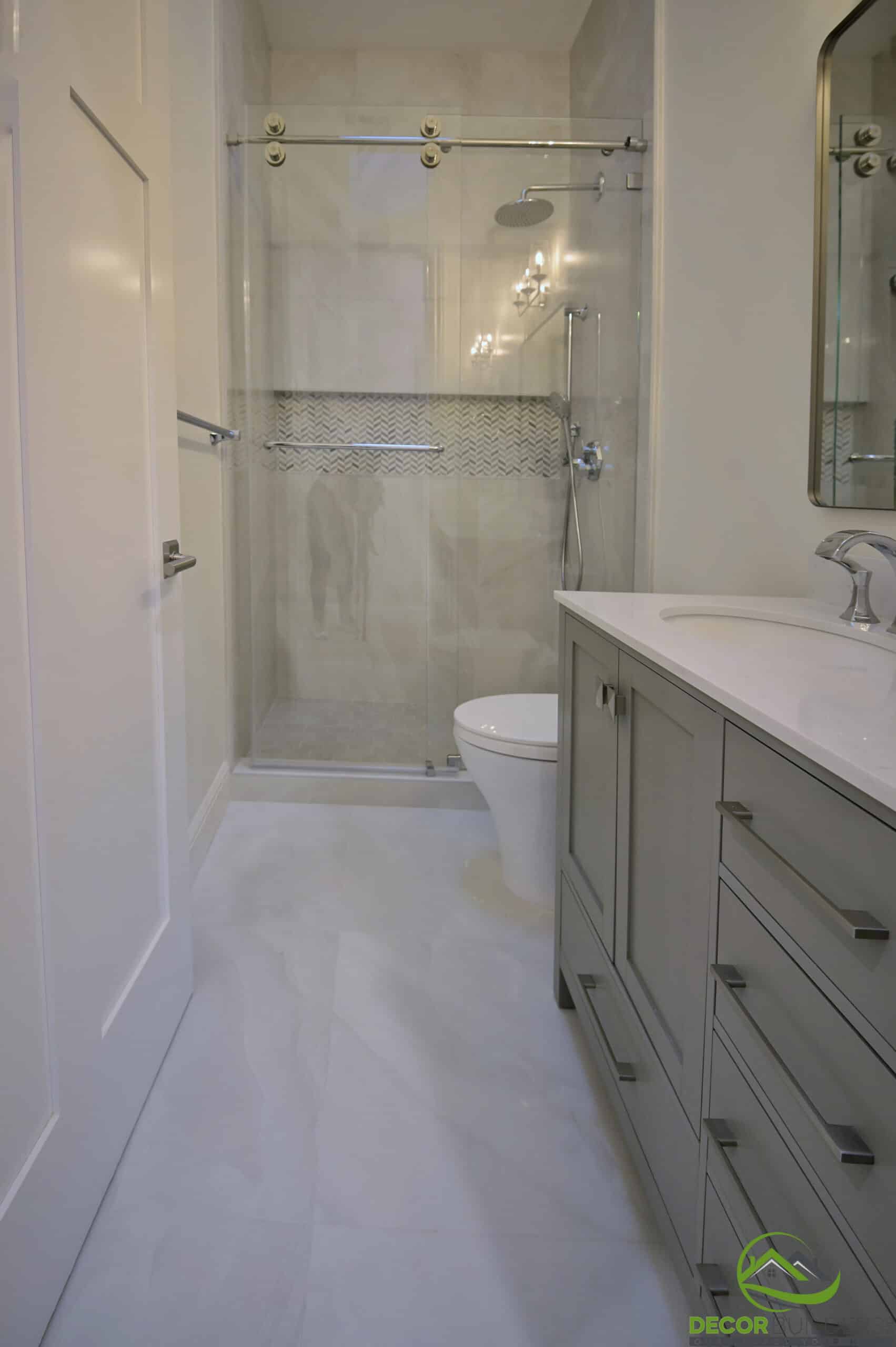 Bathroom with glass shower and sage green vanity, part of a bathroom renovation in Cupertino, CA
