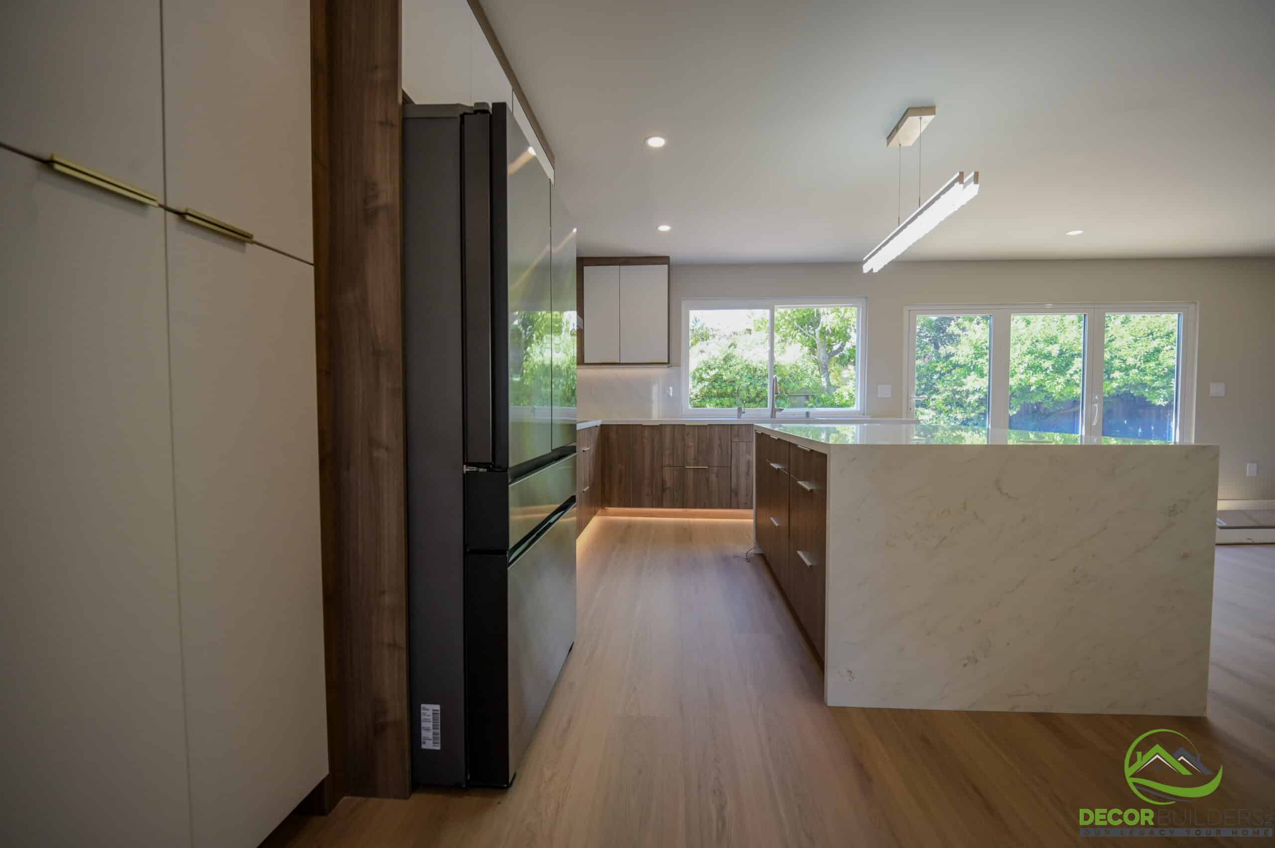 Kitchen remodel with quartz waterfall island, wood cabinetry and LED under-cabinet lighting, Foster City CA