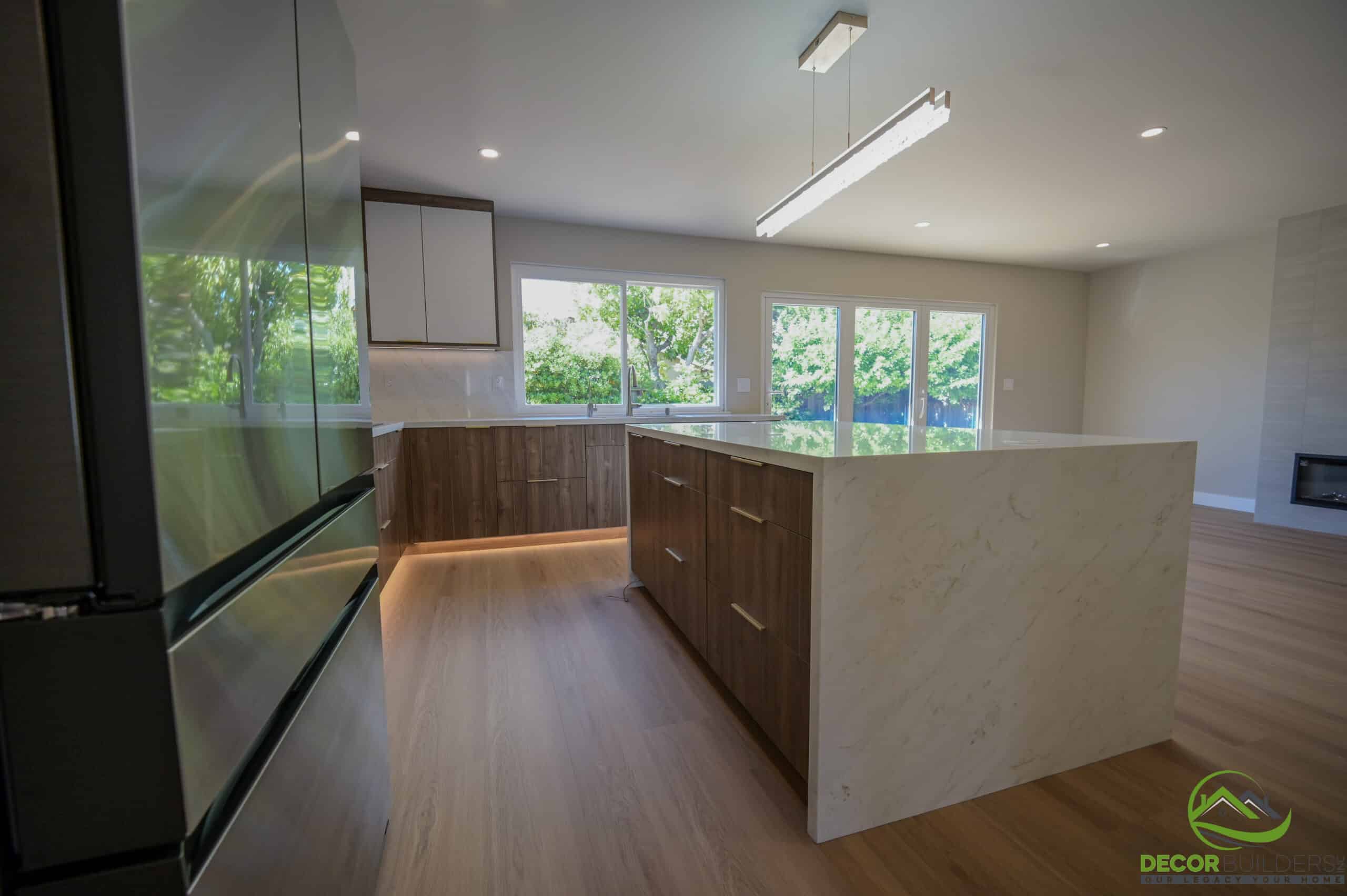 Custom home kitchen with quartz waterfall island, wood lower cabinets, LED lighting, and garden windows, Foster City CA