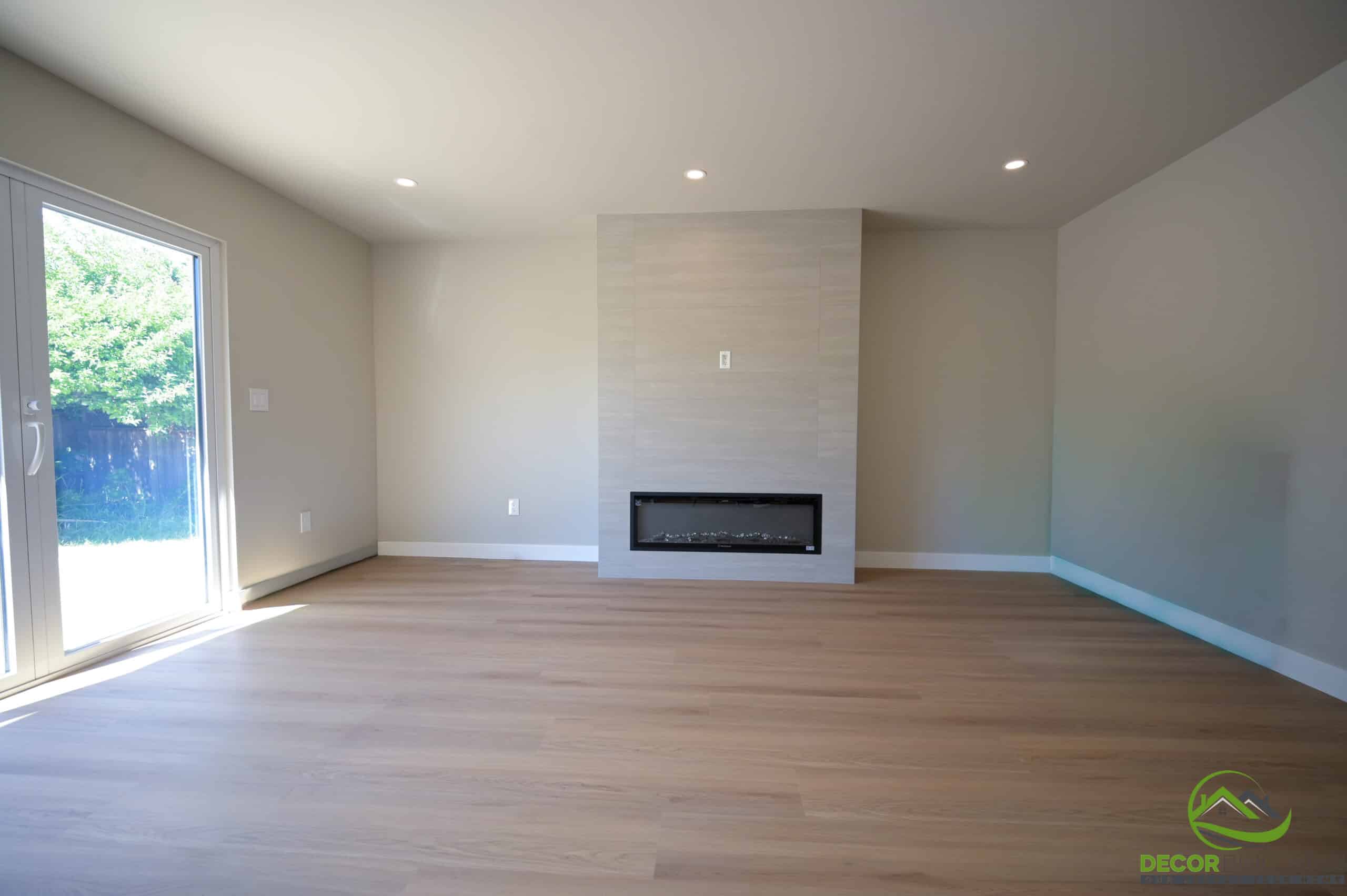 Custom home construction living room with linear fireplace, hardwood floors, and sliding glass door, Foster City CA