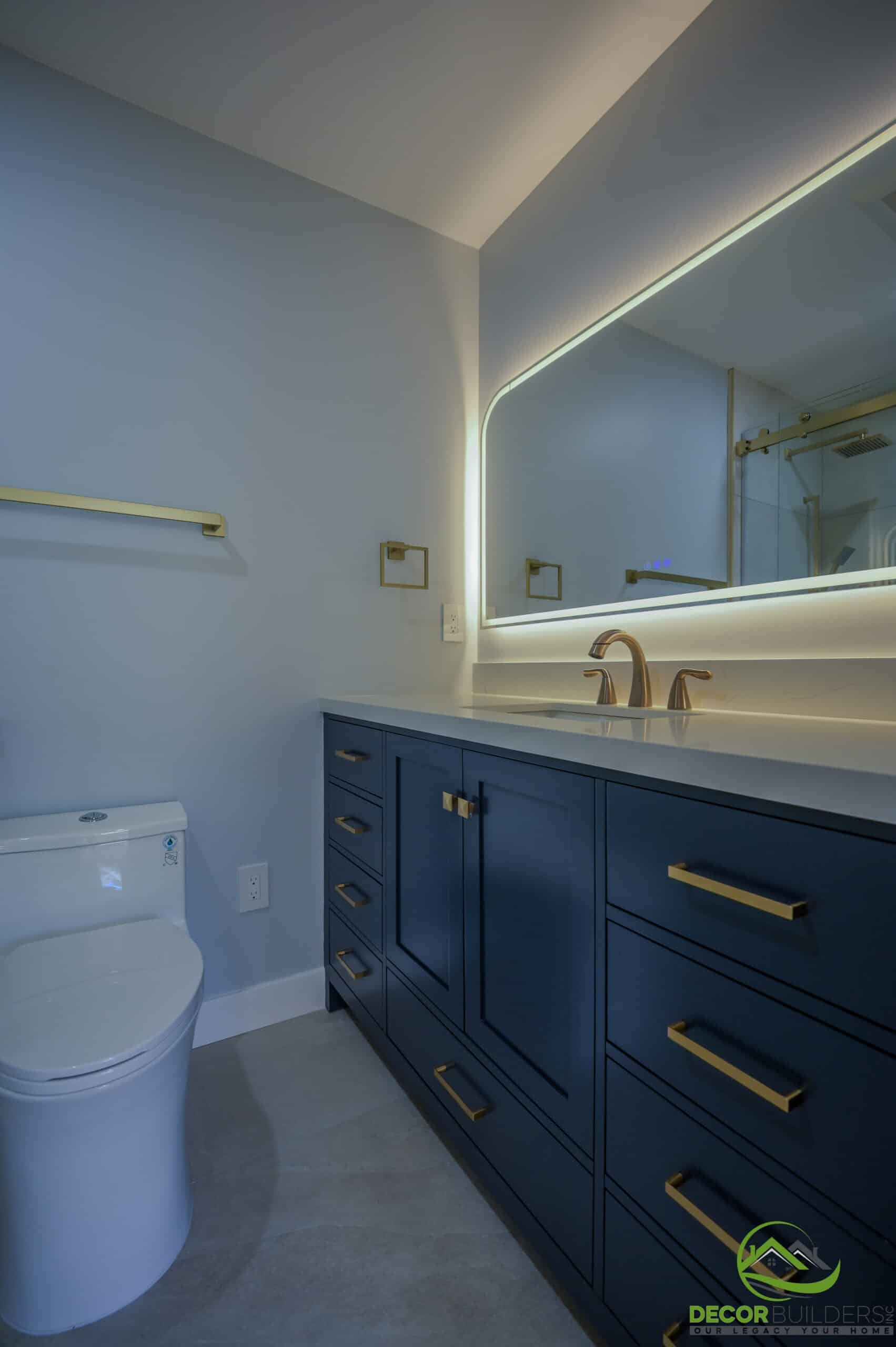 Bath remodeling navy vanity with LED backlit mirror, gold hardware, and undermount sink, Foster City CA