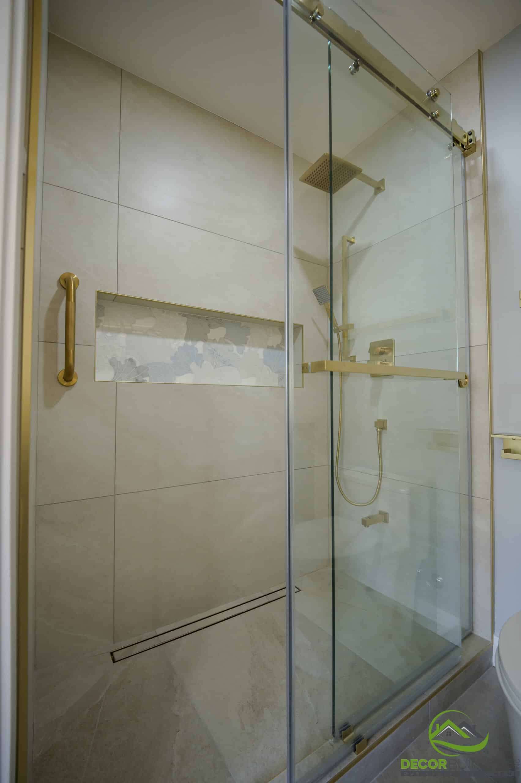 Bathroom renovation frameless glass shower with rain head, gold fixtures, and decorative niche, Foster City C