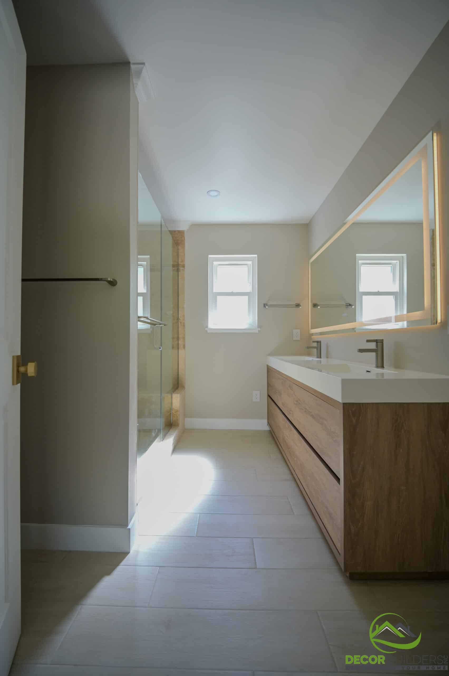 Home remodeling master bathroom with floating wood vanity, LED mirror, and frameless glass shower, Foster City CA