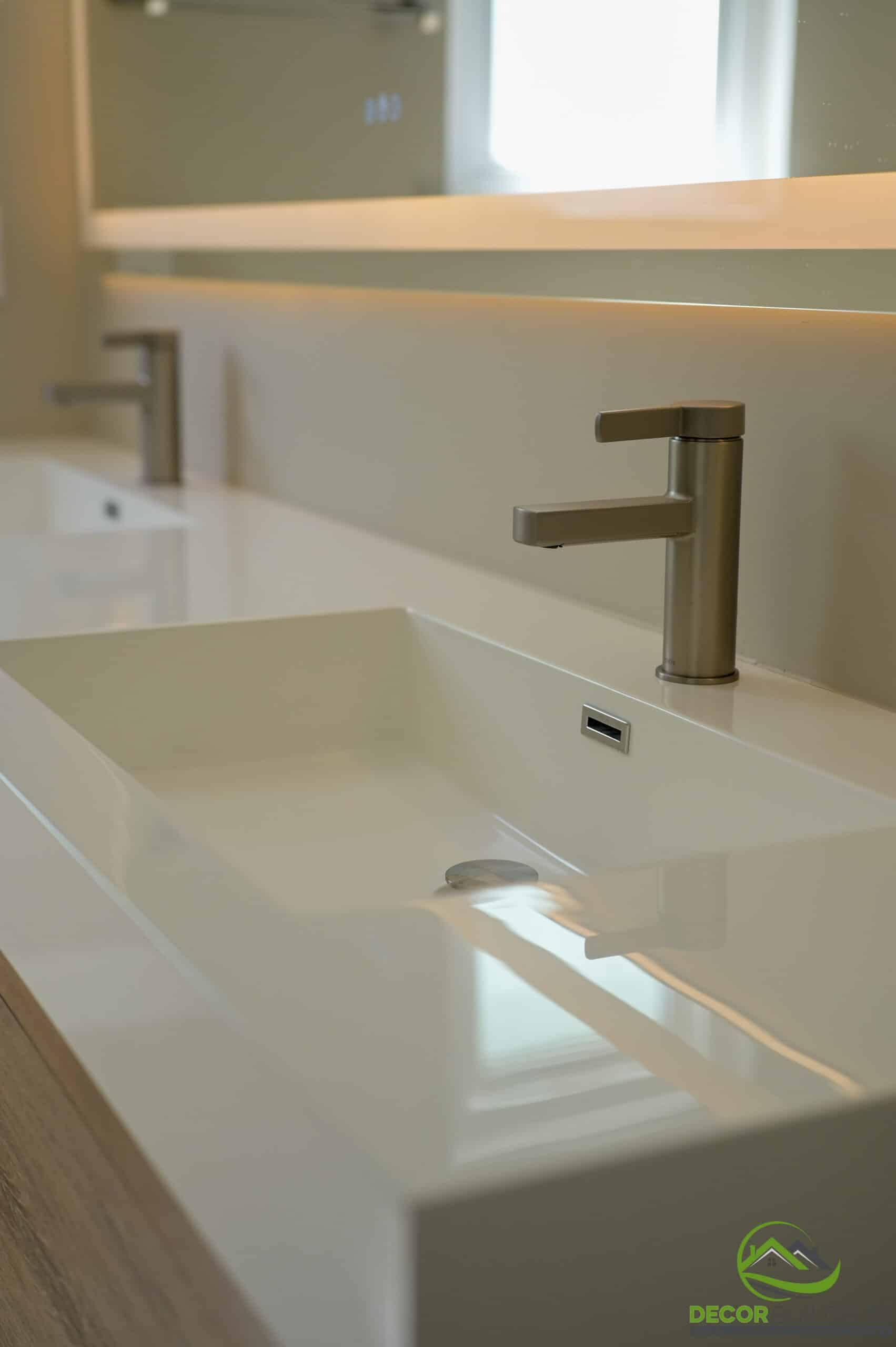 Bathroom remodel double trough sink close-up with brushed nickel faucets and backlit mirror, Foster City CA